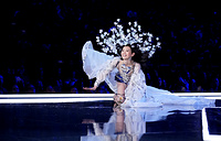 Model Ming Xi falls as she presents a creation during the 2017 Victoria's Secret Fashion Show in Shanghai, China, November 20